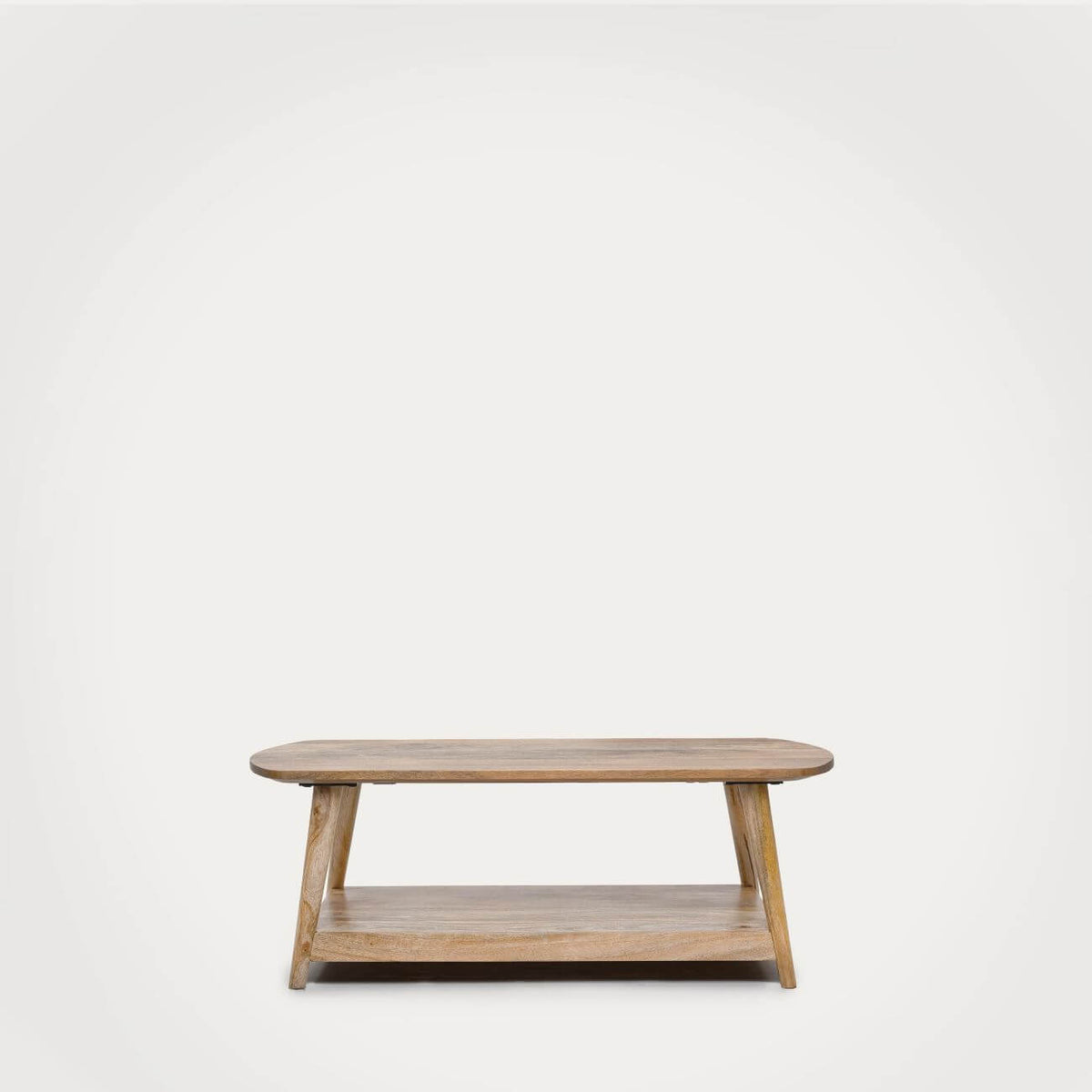 A modern low wooden coffee table with a rounded rectangular top, angled legs, and a lower shelf.