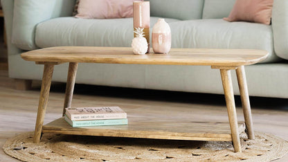 A light natural wood coffee table with a lower shelf.