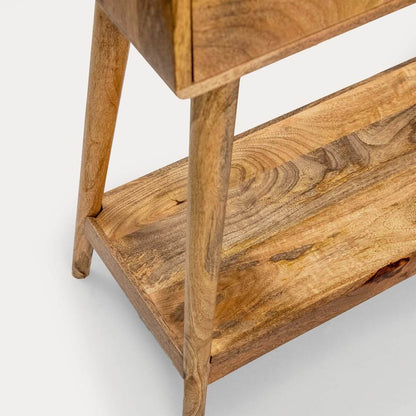 Close-up of a wooden shelf or side table showing the warm medium-brown wood grain, legs, and lower shelf.