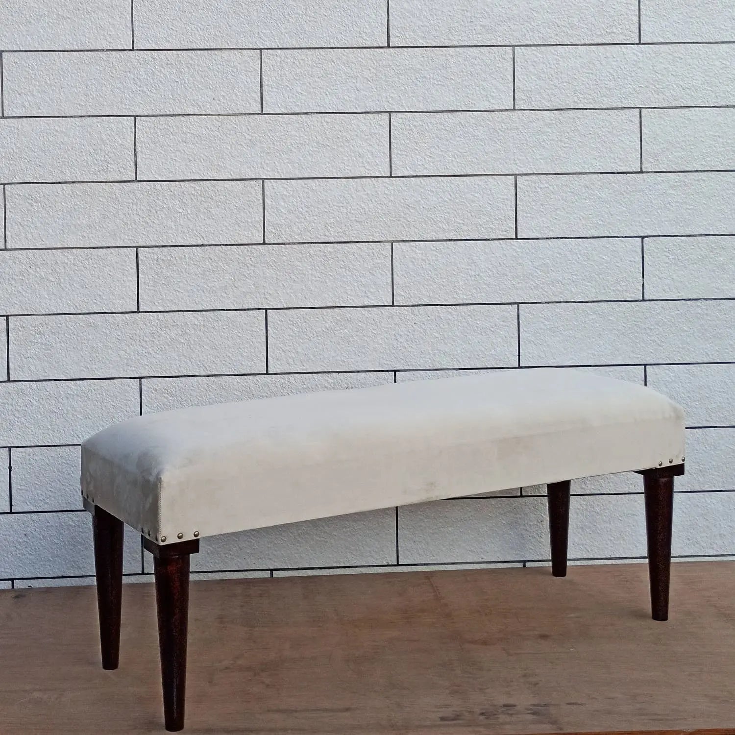 Solid Sheesham wood Beige upholstered bench with dark round wooden legs.