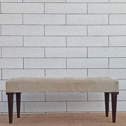 Beige bench with dark round wooden legs.