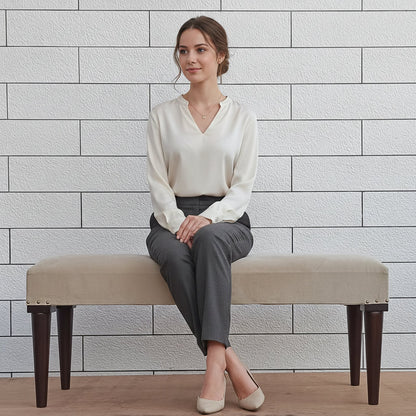 Beige bench with dark round wooden legs.