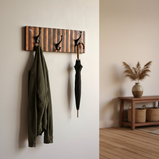Wooden wall hook with striped design and three black hooks.