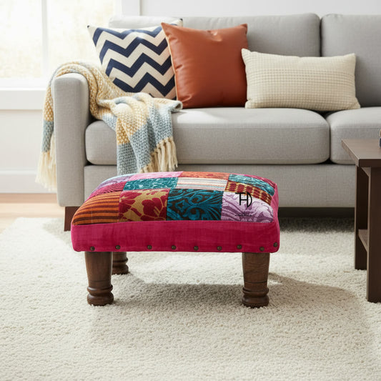 Colorful patchwork ottoman with wooden legs. 