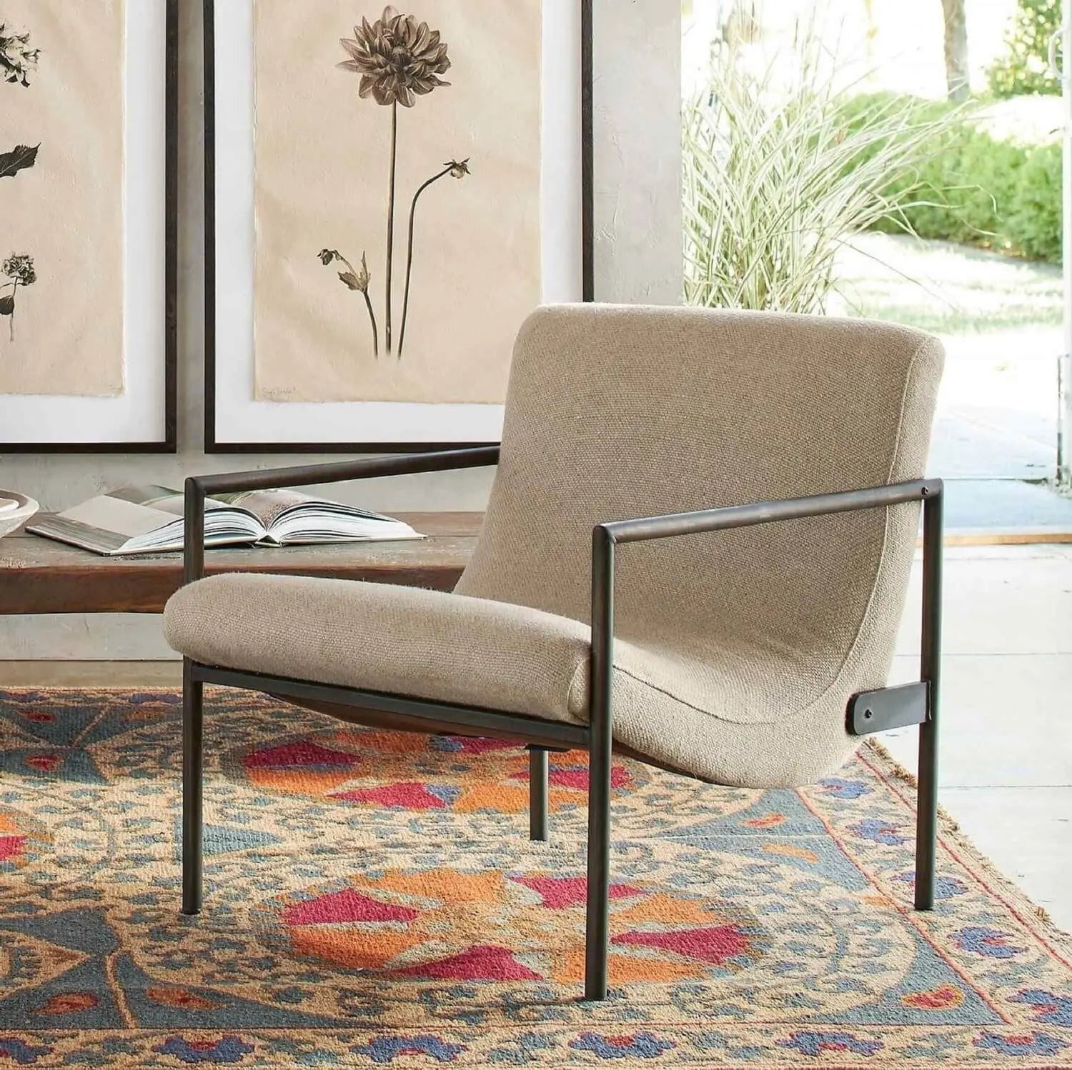 Beige armchair with black metal frame.