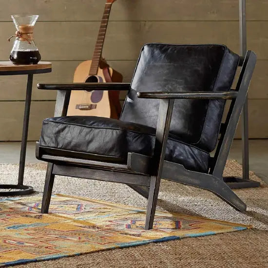 A black Cortez lounge chair with a cushioned seat and back, Sheesham wood structure.