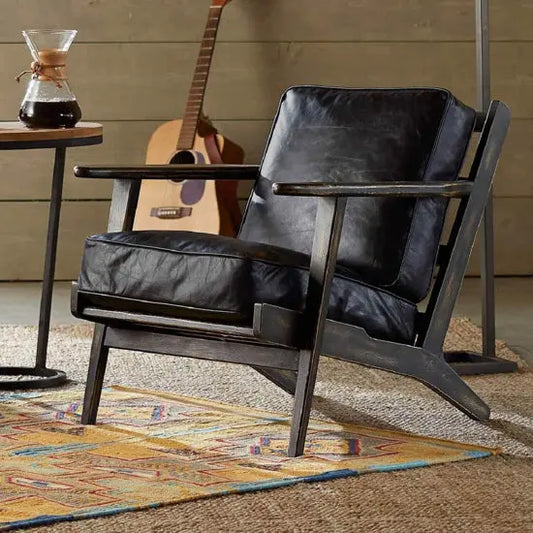 A black Cortez lounge chair with a cushioned seat and back, Sheesham wood structure.