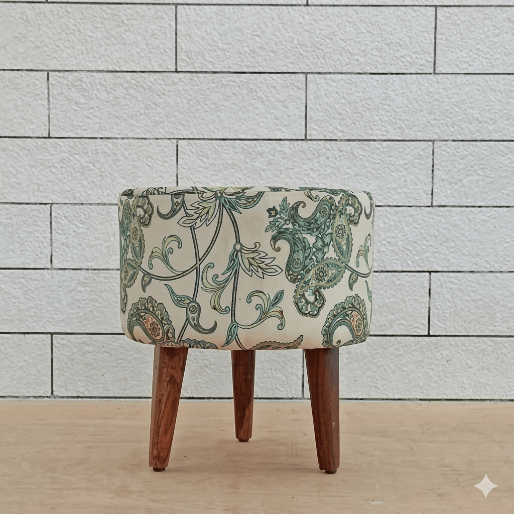 Small ottoman with floral pattern and wooden legs.