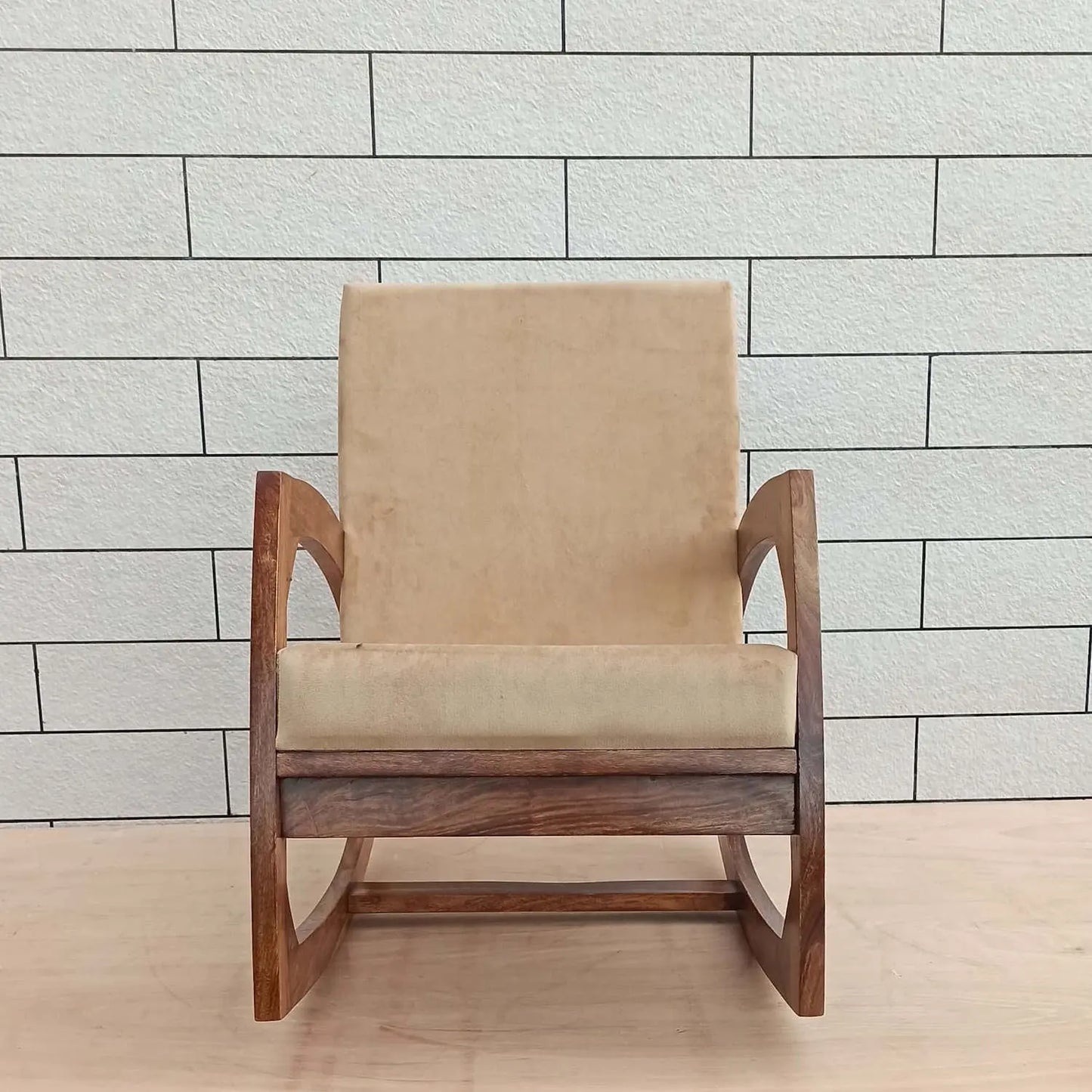 Beige cushioned Designer rocking chair with wooden frame. 