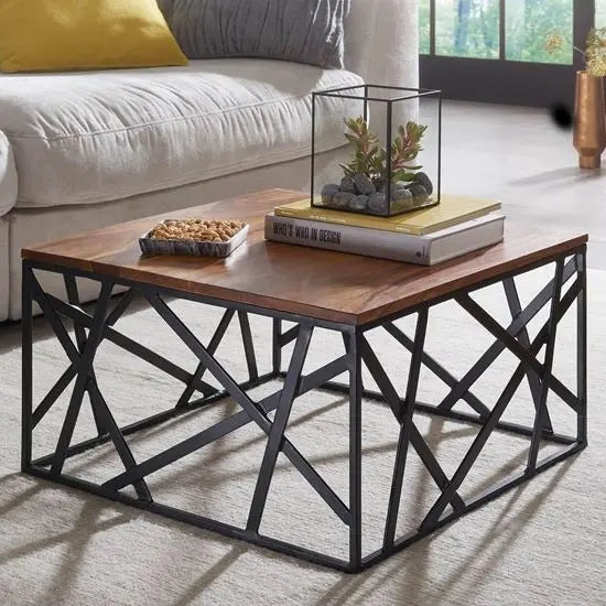 A square-shaped coffee table with a shessham wood top and black metal base. 