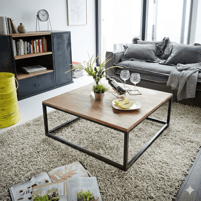 A square coffee table with a natural sheesham wood top and black metal frame base. 