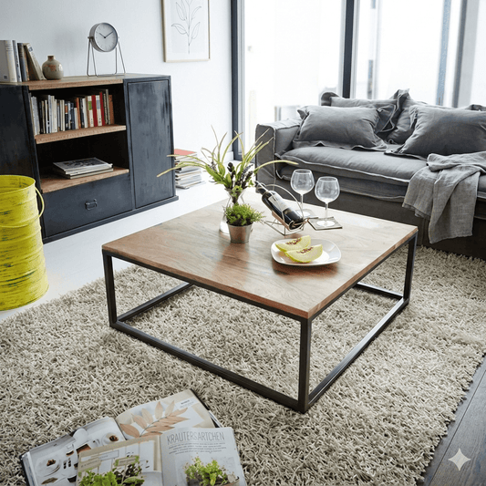 A square coffee table with a natural sheesham wood top and black metal frame base. 