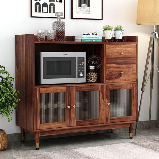A mid-century modern wooden sideboard cabinet with a microwave and decorative items. 