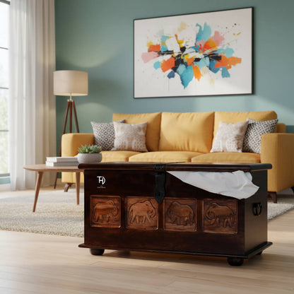 Wooden trunk with elephant carvings on a Natural finish. 