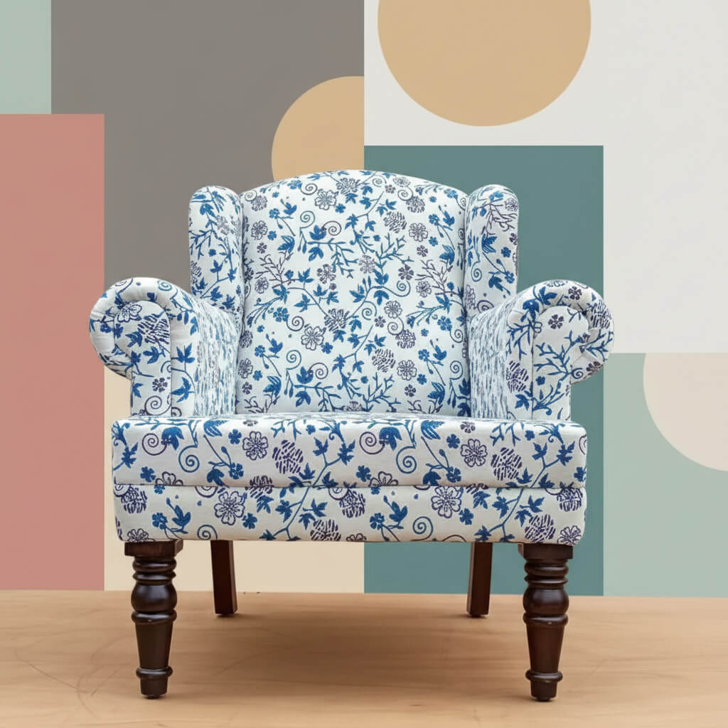 A blue floral upholstered Genova Wing chair with Sheesham wood frame and knockdown legs.