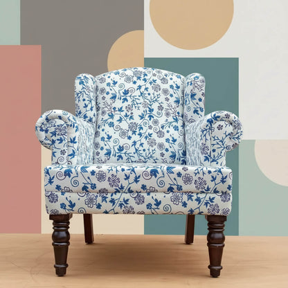A blue floral upholstered Genova Wing chair with Sheesham wood frame and knockdown legs.