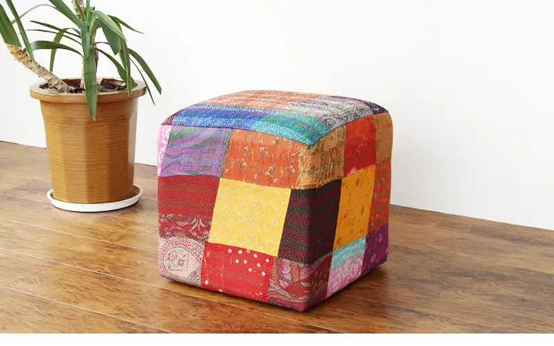 Colorful patchwork cube ottoman. 