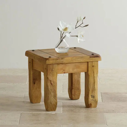 A square-shaped side table made of mango wood with visible grain patterns. 