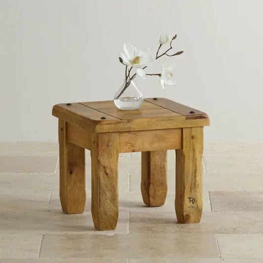 A square-shaped side table made of mango wood with visible grain patterns. 
