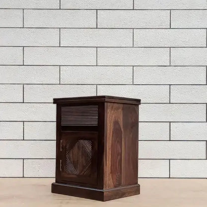 A wooden bedside table with a group design on the front made in Solid sheesham wood.