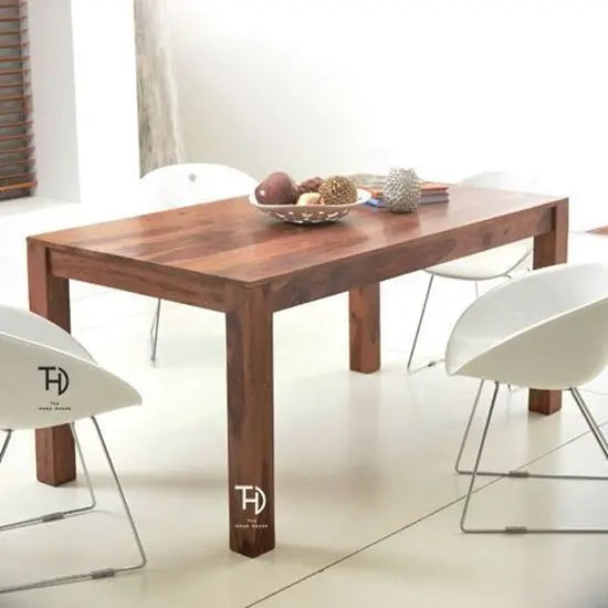 A solid Sheesham wood dining table with a smooth natural finish, featuring knockdown legs, Simple dining table in wood.
