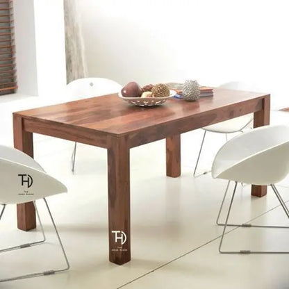 A solid Sheesham wood dining table with a smooth natural finish, featuring knockdown legs, Simple dining table in wood.