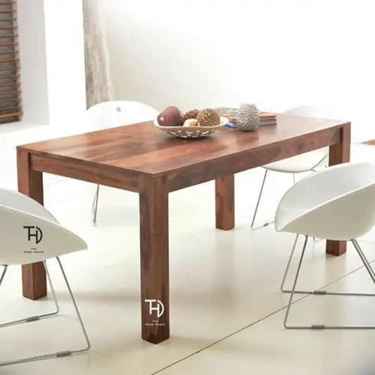 A solid Sheesham wood dining table with a smooth natural finish, featuring knockdown legs, Simple dining table in wood.
