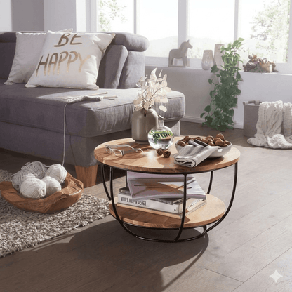 A round coffee table with acacia wood top and black metal frame with two shelves for keeps items. 