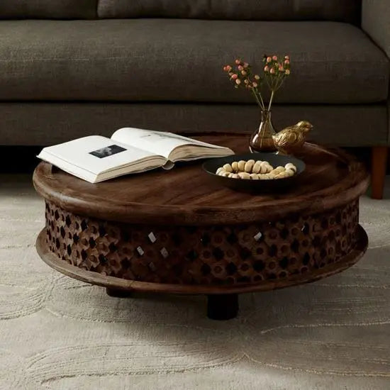 Solid wood hand-carved, round shaped isha coffee table with intricate patterns.