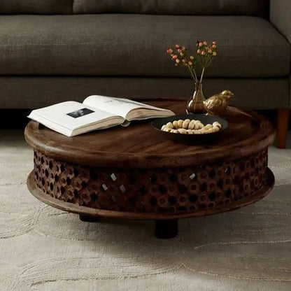 Solid wood hand-carved, round shaped isha coffee table with intricate patterns.