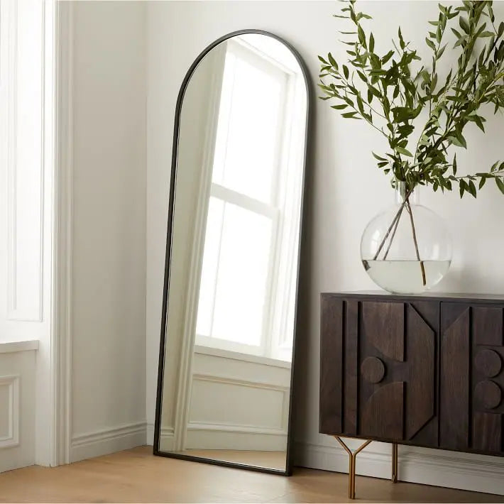 Arched floor mirror in a living room.