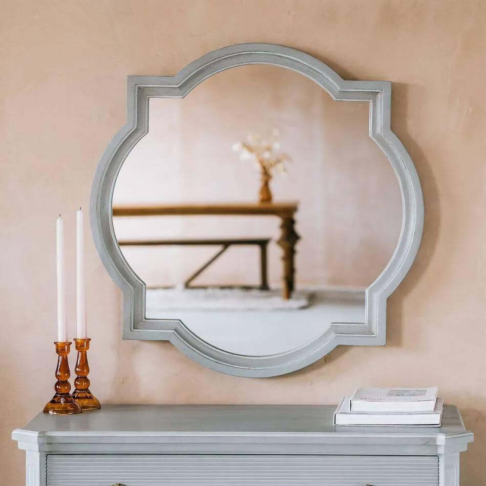 A large scalloped oval wall mirror with a distressed white frame made in real mango wood with mdf and mirror.