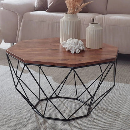 Hexagonal coffee table with wooden top and black metal frame in a living room setting.
