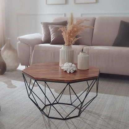A Hexagonal brown coffee table with a geometric black metal base.