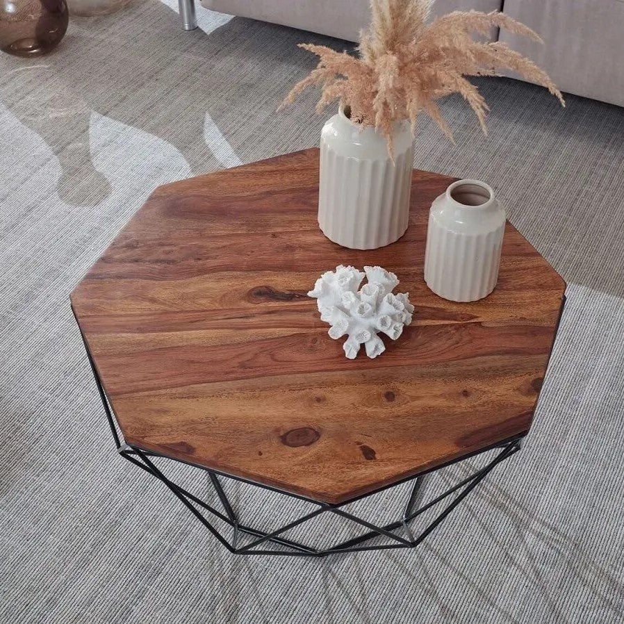 Hexagonal wooden Kerry coffee table with geometric black metal base.