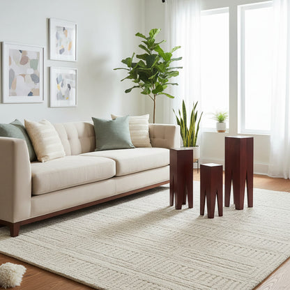Three wooden end tables in a set, with a dark finish.