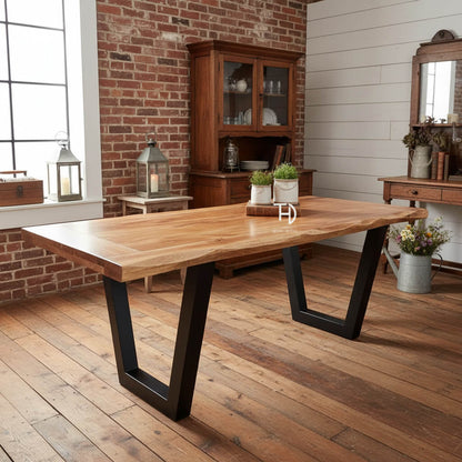 A rectangular dining table with a live edge wood top and black metal legs.