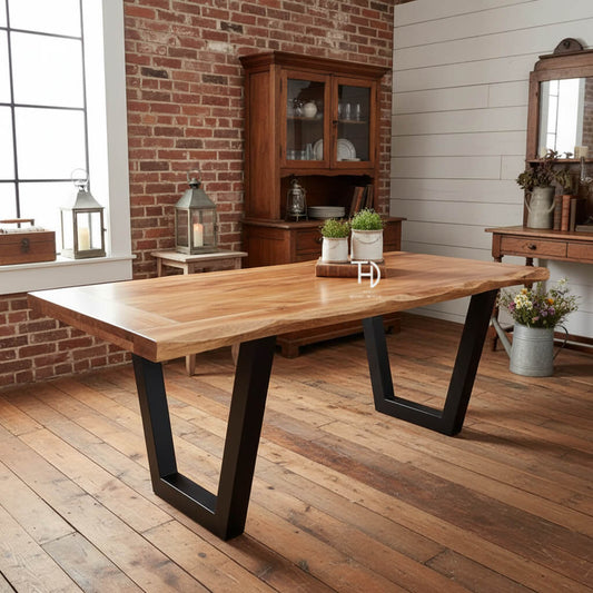 A rectangular dining table with a live edge wood top and black metal legs.
