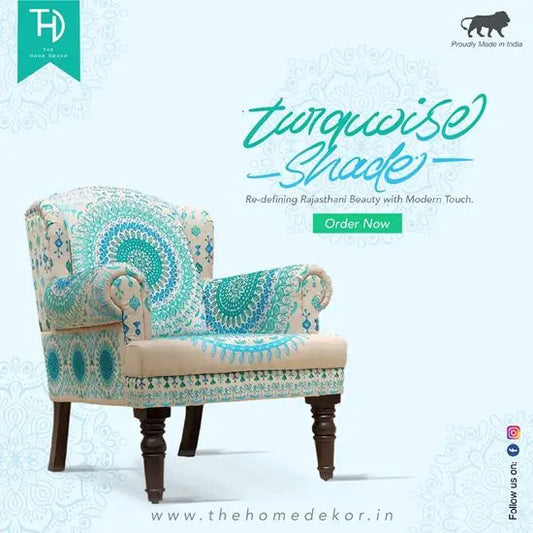 A blue Maharaja sofa with intricate embroidery, featuring a wooden structure and knockdown legs.