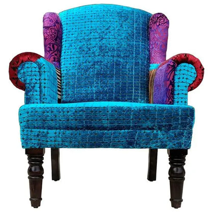 A blue Maharaja sofa with velvet upholstery and wooden legs online.