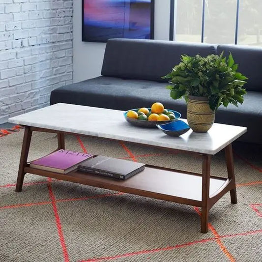 A rectangular coffee table with a white marble top and brown sheesham wood base. 