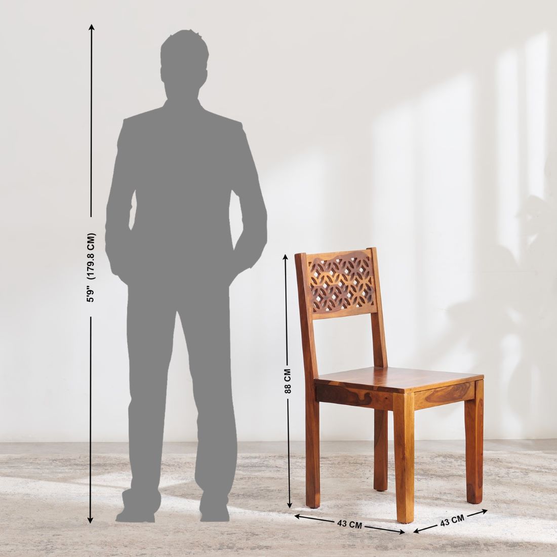 A wooden dining chair shown next to a gray human silhouette with height measurement lines, indicating the chair's 58 cm height and 43 cm width. The chair has a warm medium-brown finish with a geometric cutout pattern on the backrest.
