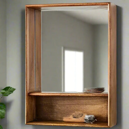 A rectangular storage mirror with a wooden frame, featuring a mirror on the upper half and shelve at base.