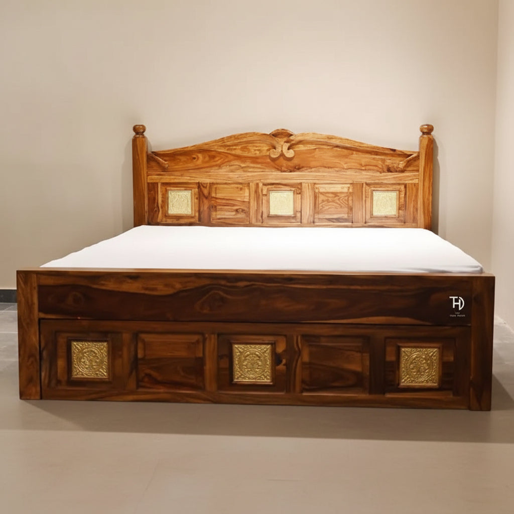 A traditional Nawab king size bed made of Sheesham wood with brasswork, featuring a storage drawer and decorative panels at the headboard.