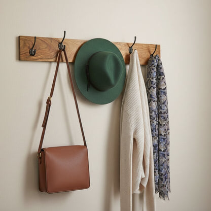 Wooden wall hook rack with five hooks.