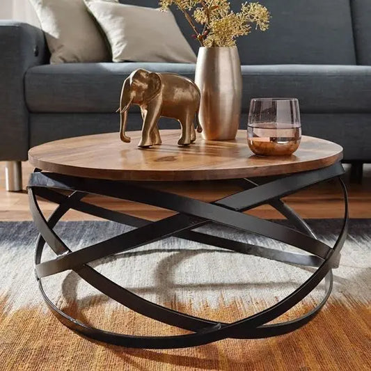 A round shaped Patti coffee table with a wood top and metal base. 