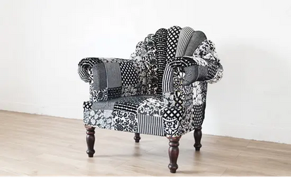 A black and white upholstered Peacock sofa in patchwork.