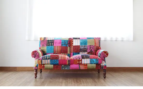 Colourful patchwork two seater sofa.