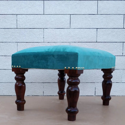 Teal stool with wooden carving legs.