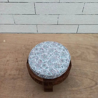 solid wood hand craved round footstool in natural finish. 